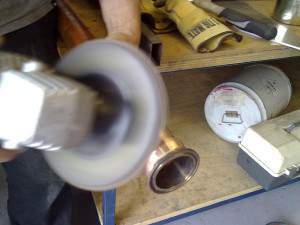 Giving the tri-clover fitting a bit of a rub down. Tri-clover is stainless, bit of a hassle brazing to copper.