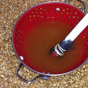 Colander pushing down the grain