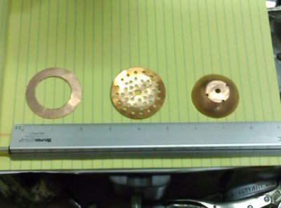 These are the 3 types of plates I used.<br />The one on the left fits tight to the column wall and puts the reflux back in the center of the column.<br />The center one is a strainer type and gets an inch coating of 3/8&quot; dia marbles on it.<br />The one on the right is a catch and splatter type, it is made of 1 1/2&quot; test caps hammered on a 2&quot; trailer ball.