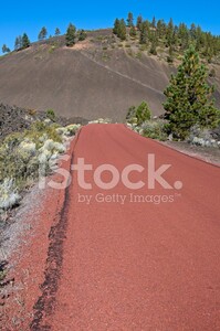 14386061-red-road-leading-to-cinder-cone-in-oregon.jpg